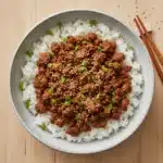 Korean-style ground turkey served over white rice, topped with sesame seeds and sliced green onions.