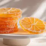 Candied orange slices coated in sugar with a glossy, translucent finish.