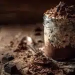 Brownie batter overnight oats with a rich chocolate color and creamy texture in a jar.