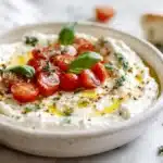 Caprese Dip Recipe: A Family-Friendly Delight! 7 Caprese dip with melted mozzarella, cherry tomatoes, basil, and balsamic drizzle in a baking dish