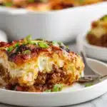 Chili Stuffed Casserole 7 Chili stuffed casserole layered with seasoned beef, beans, cheese, and baked until bubbly