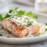 Greek Yogurt-Marinated Salmon 7 Greek yogurt–marinated salmon with herbs, lemon, and a lightly golden crust on a plate