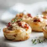 Puff pastry pizza bites topped with melted cheese and pepperoni, baked until golden