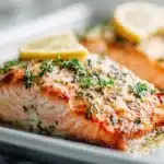Sheet pan lemon garlic butter salmon baked with lemon slices, herbs, and a buttery glaze