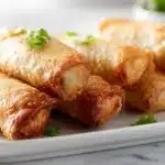 Easy Voodoo Egg Rolls 7 Voodoo egg rolls filled with spicy seasoned meat and vegetables, fried until crispy and golden
