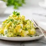 Easy Avocado Egg Salad 7 Avocado egg salad with chopped hard-boiled eggs, creamy avocado, herbs, and light seasoning mixed in a bowl.