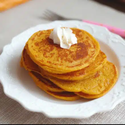 Baby pumpkin pancakes small and fluffy served on a plate