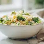 Broccoli cheddar rice with tender broccoli florets and melted cheddar cheese in a bowl