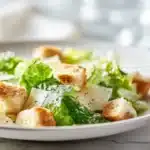 Original Caesar Salad Dressing 7 Caesar salad dressing creamy and smooth in a small bowl with herbs