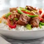 Cajun rice cooked with ground meat, vegetables, and spices served in a bowl