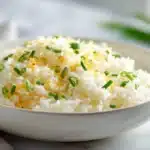 Cheesy rice with melted cheese stirred into fluffy rice, served in a bowl