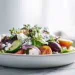 Cowboy Salad 7 Hearty cowboy salad loaded with ground beef, beans, corn, tomatoes, cheese, and crunchy vegetables tossed in a creamy dressing.