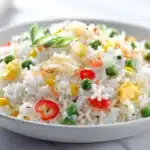 Fried rice stir-fried with vegetables, eggs, and seasonings in a bowl
