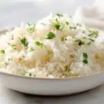 Garlic butter rice with fluffy rice, melted butter, and fresh herbs in a bowl