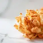 Mini air fryer blooming onions golden and crispy with dipping sauce