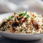 Mushroom rice cooked with tender mushrooms, herbs, and fluffy rice in a bowl