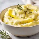 Smooth parsnip puree served in a bowl, creamy and velvety with a light garnish on top.