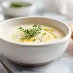 Spiced Parsnip Soup 7 Spiced parsnip soup blended smooth and creamy, served warm with a sprinkle of spices and fresh herbs in a bowl.