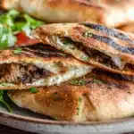 Golden crispy arayes stuffed pita filled with seasoned ground meat and herbs, grilled until perfectly toasted