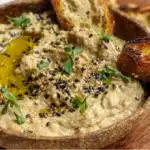 Baba ganoush creamy roasted eggplant dip garnished with olive oil and herbs