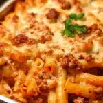 Baked ziti pasta casserole with marinara sauce, melted mozzarella, and creamy ricotta cheese