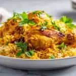 Chicken Kabsa (Arabian Chicken and Rice) 6 Chicken kabsa served with spiced rice, tender chicken, and toasted nuts