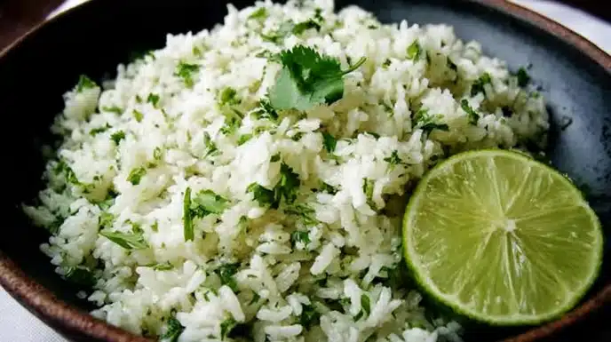 Cilantro Lime Rice 4 Fluffy cilantro lime rice garnished with fresh chopped cilantro and lime wedges in a bowl