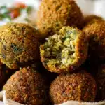 Crispy golden falafel balls made from chickpeas, herbs, and spices, served with fresh vegetables and tahini sauce