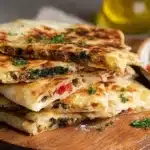 Traditional Turkish gozleme flatbread filled with cheese and spinach, cooked on a griddle until golden and crispy