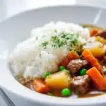 Easy Japanese Beef Curry From Scratch 6 Rich Japanese beef curry served over fluffy white rice with tender beef chunks, carrots, and potatoes in a thick savory sauce