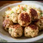 Oven baked turkey and rice meatballs golden and arranged on a plate