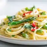 Pasta primavera tossed with colorful vegetables in a light lemon garlic sauce