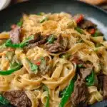 Creamy Philly cheesesteak pasta with tender beef strips, bell peppers, onions, and melted cheese