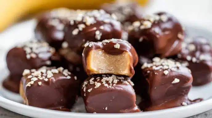 Frozen chocolate peanut butter banana bites on a plate